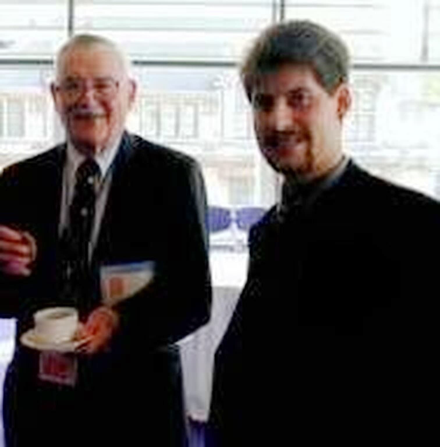 James M. Buchanan and Rahim Taghizadegan stand beside one another at an event in the United States