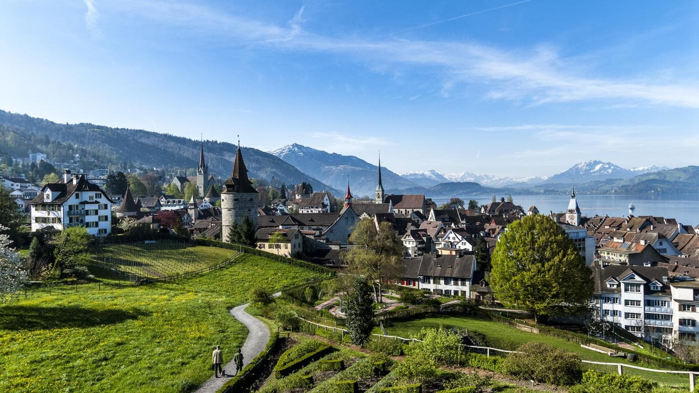 Zug's old town lies between hills, Lake Zug, and the Alps.